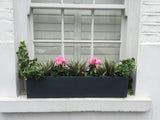 Artificial window box with grasses and cyclamen